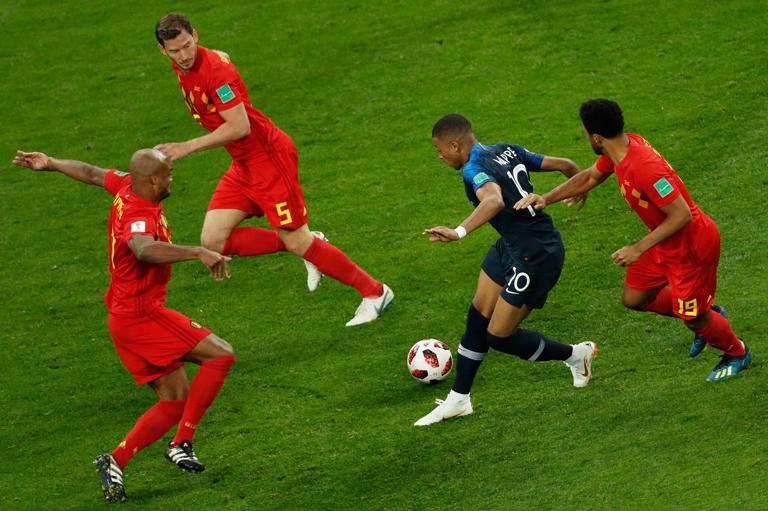 France's forward Kylian Mbappe (C) runs with the ball as he vies for it with Belgium's midfielder Moussa Dembele (R), Belgium's defender Jan Vertonghen (2nd L) and Belgium's defender Vincent Kompany (L) during the Russia 2018 World Cup semi-final football match between France and Belgium at the Saint Petersburg Stadium in Saint Petersburg on July 10, 2018. (Photo by Adrian DENNIS / AFP) / RESTRICTED TO EDITORIAL USE - NO MOBILE PUSH ALERTS/DOWNLOADS        (Photo credit should read ADRIAN DENNIS/AFP via Getty Images)